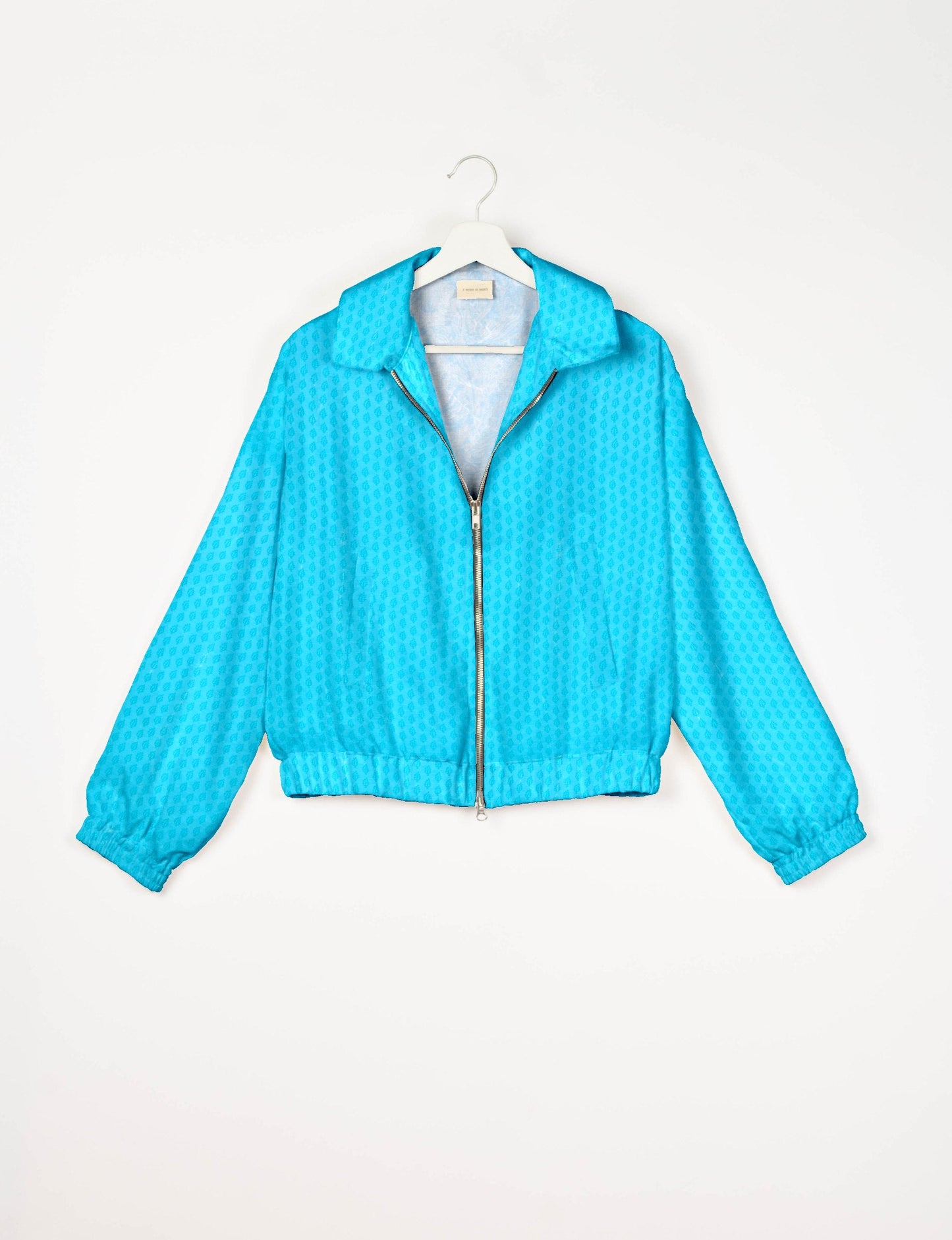 Stylish BOMBER JACKET, an upcycled clothing masterpiece with a cute cropped shape, elasticated details, and detachable metallic zipper. Contrast sari print lining adds a unique touch. Explore sustainable and eco-friendly fashion.