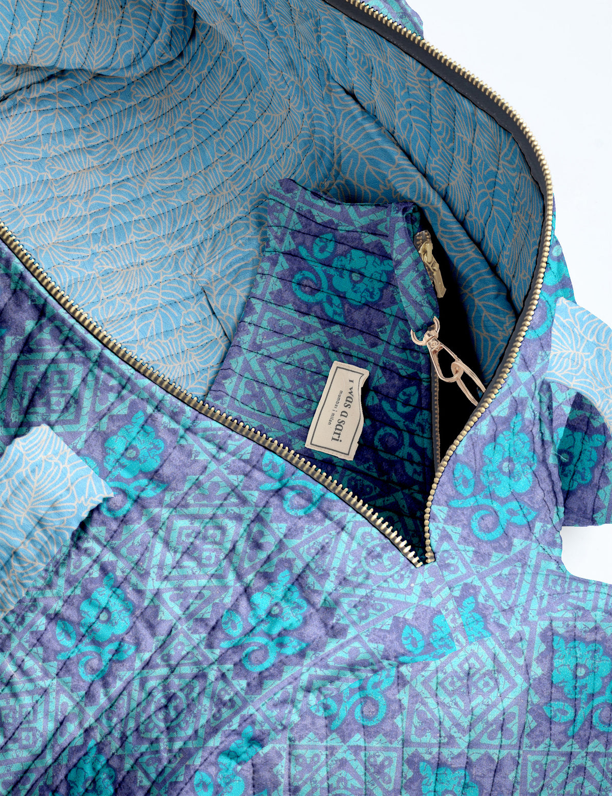 Brown paisley quilted bowling bag with dual handles, front zipper pocket, and "I was a sari" label on front side