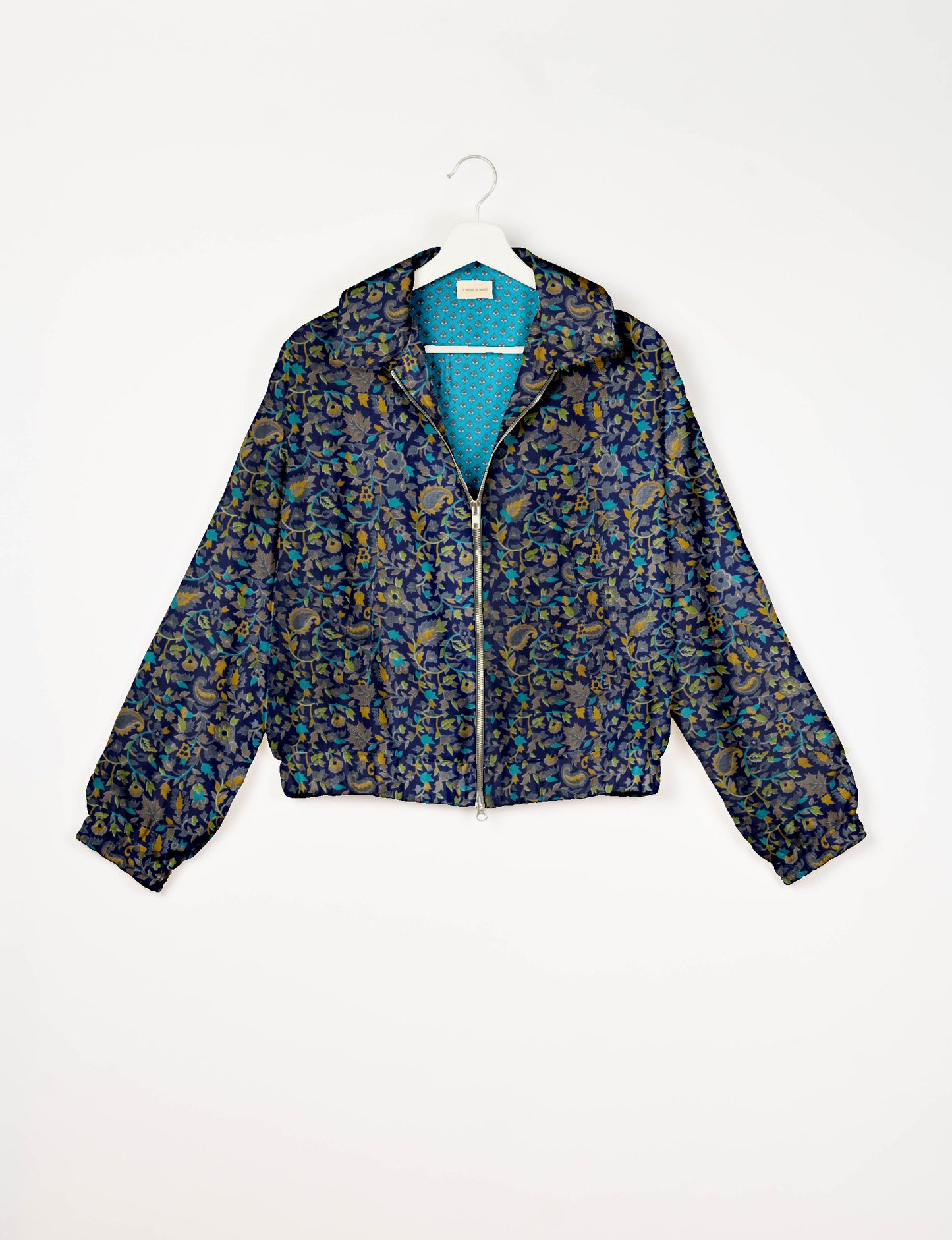 Upcycled Bomber Jacket made from recycled sari materials, featuring a cute cropped shape, elasticated hem and cuffs, and contrast sari print lining. Sustainable apparel promoting eco-friendly fashion and ethical clothing.