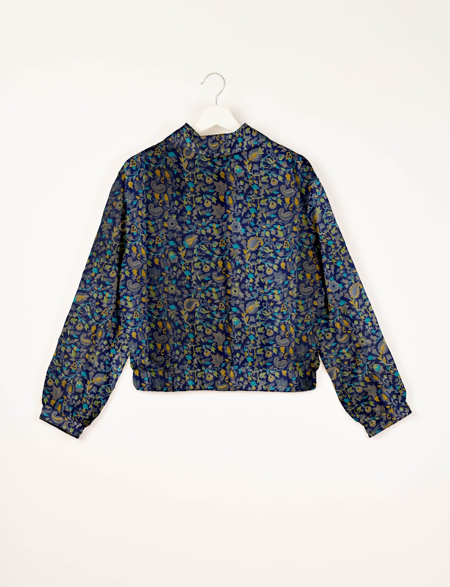 Upcycled Bomber Jacket made from recycled sari materials, featuring a cute cropped shape, elasticated hem and cuffs, and contrast sari print lining. Sustainable apparel promoting eco-friendly fashion and ethical clothing.