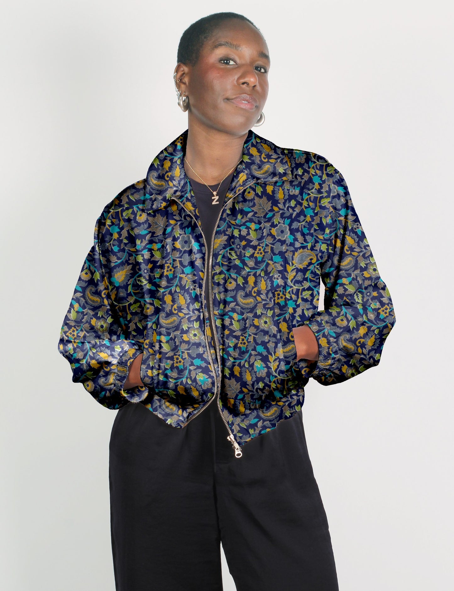 Upcycled Bomber Jacket made from recycled sari materials, featuring a cute cropped shape, elasticated hem and cuffs, and contrast sari print lining. Sustainable apparel promoting eco-friendly fashion and ethical clothing.