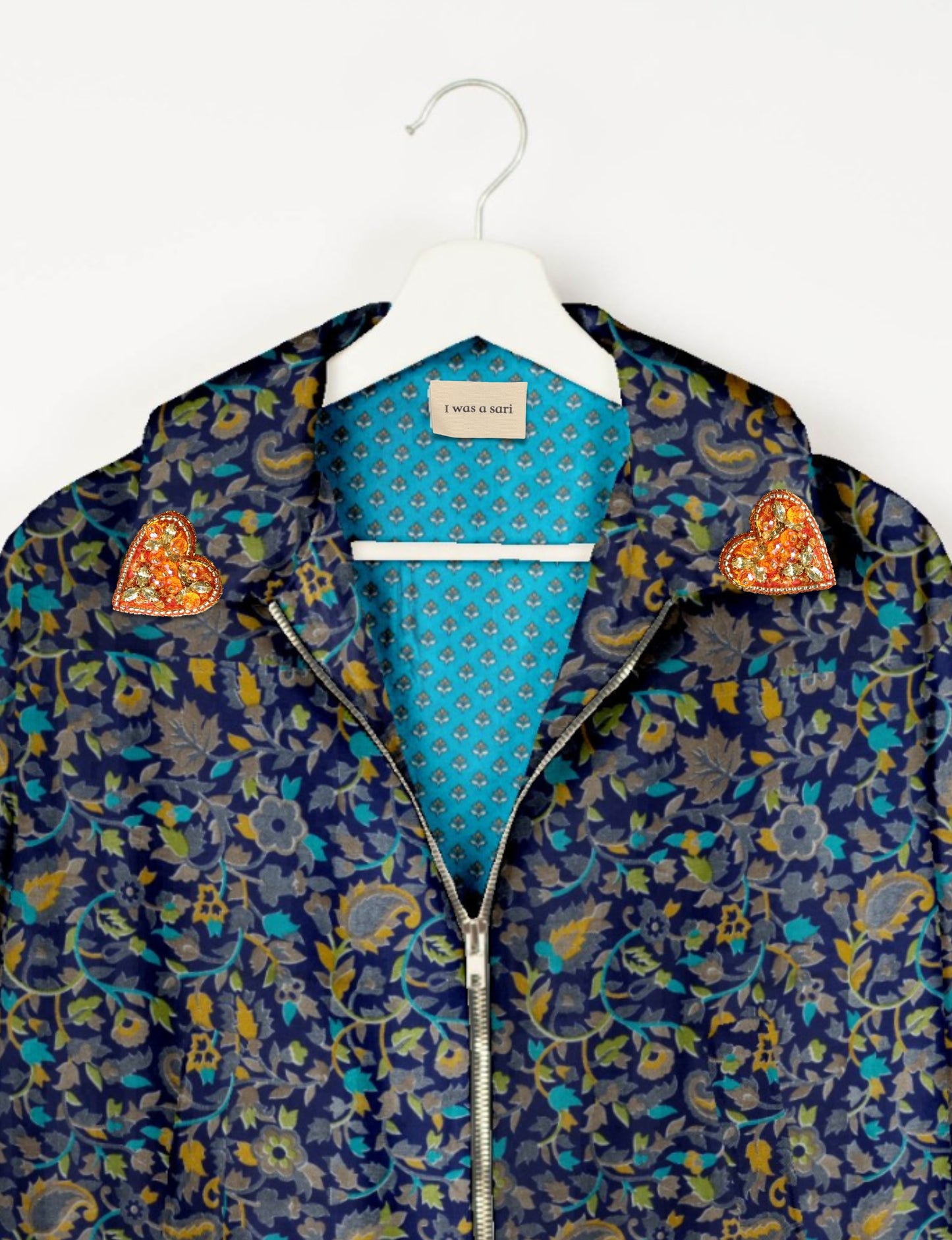 Make a bold statement with our Heart Drop Earrings, a symbol of conscious luxury and ethical fashion. Handcrafted using the intricate Aari embroidery technique, these earrings are made from upcycled sari fabric, embracing slow fashion and zero waste clothing. Elevate your look with sustainable apparel that supports fair trade fashion while reducing textile waste. Choose eco-friendly fashion that speaks of love, artistry, and responsibility.