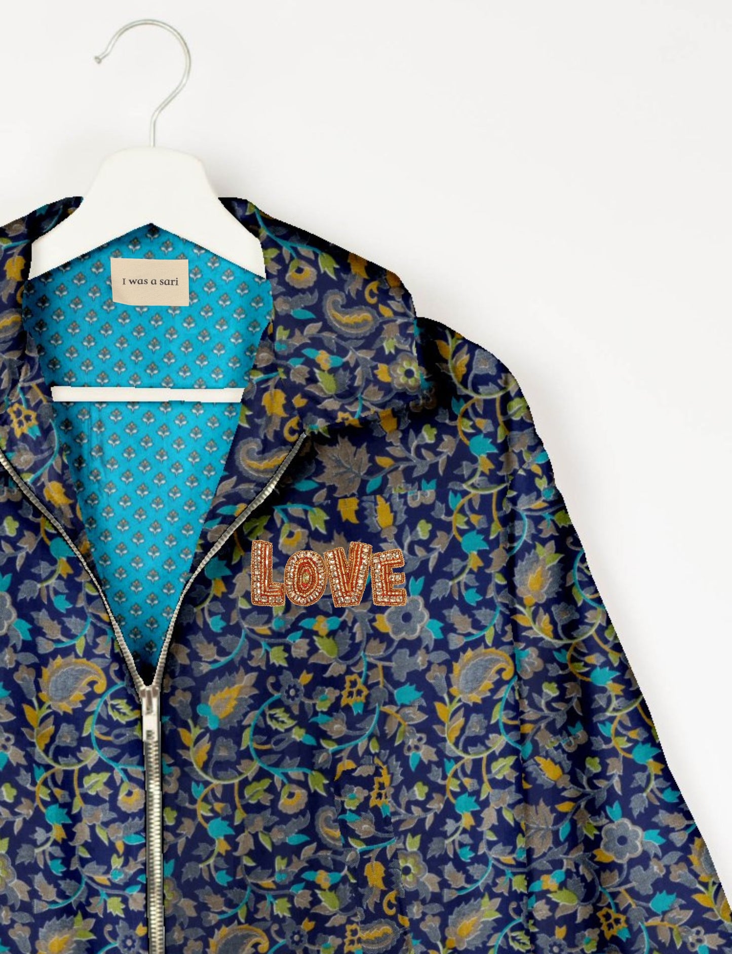 Love Bomber Jacket made from recycled fabric, featuring hand-stitched Aari embroidery. A unique piece of zero-waste clothing, part of the circular fashion movement. Designed with upcycled materials for a stylish yet environmentally friendly clothing choice.