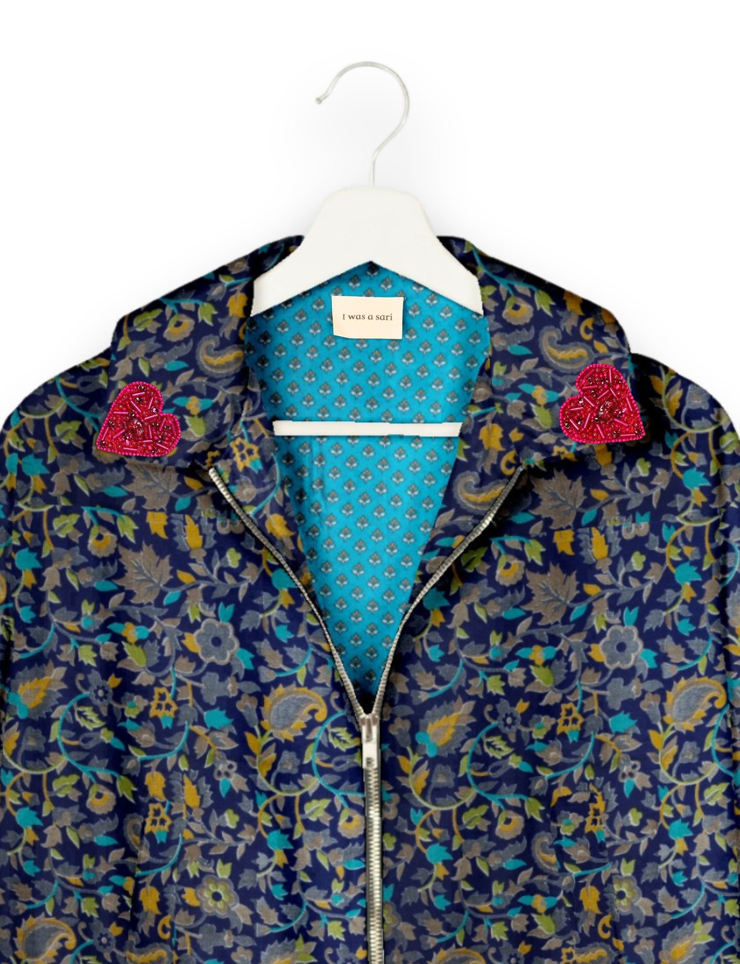 Make a bold statement with our Heart Drop Earrings, a symbol of conscious luxury and ethical fashion. Handcrafted using the intricate Aari embroidery technique, these earrings are made from upcycled sari fabric, embracing slow fashion and zero waste clothing. Elevate your look with sustainable apparel that supports fair trade fashion while reducing textile waste. Choose eco-friendly fashion that speaks of love, artistry, and responsibility.