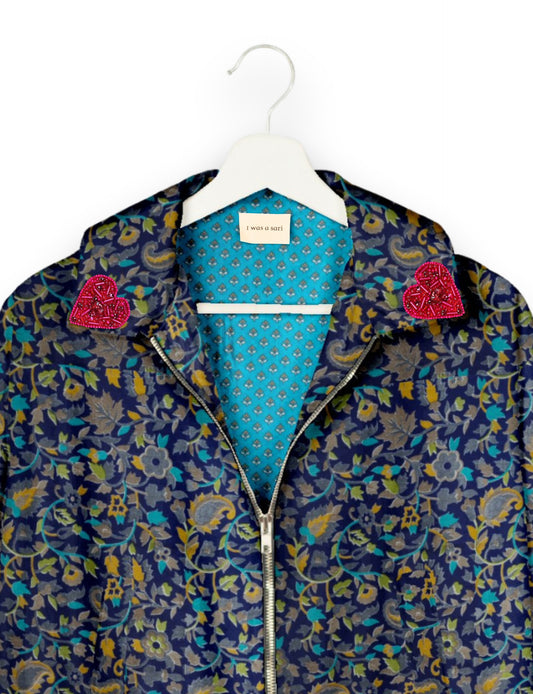 Make a bold statement with our Heart Drop Earrings, a symbol of conscious luxury and ethical fashion. Handcrafted using the intricate Aari embroidery technique, these earrings are made from upcycled sari fabric, embracing slow fashion and zero waste clothing. Elevate your look with sustainable apparel that supports fair trade fashion while reducing textile waste. Choose eco-friendly fashion that speaks of love, artistry, and responsibility.