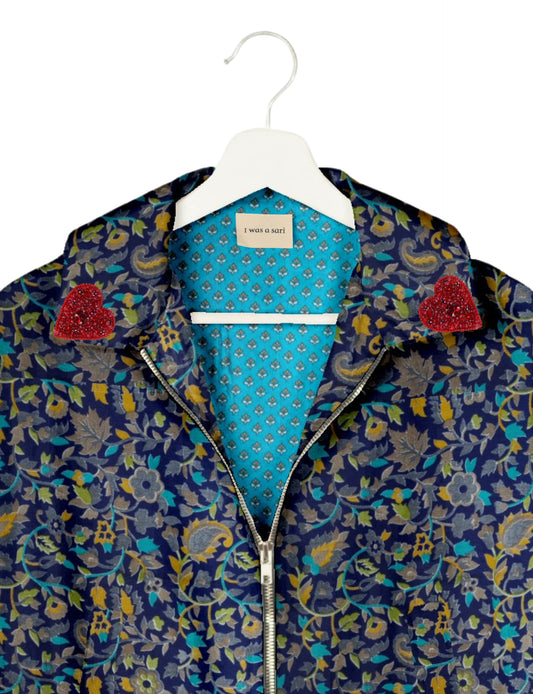 Make a bold statement with our Heart Drop Earrings, a symbol of conscious luxury and ethical fashion. Handcrafted using the intricate Aari embroidery technique, these earrings are made from upcycled sari fabric, embracing slow fashion and zero waste clothing. Elevate your look with sustainable apparel that supports fair trade fashion while reducing textile waste. Choose eco-friendly fashion that speaks of love, artistry, and responsibility.