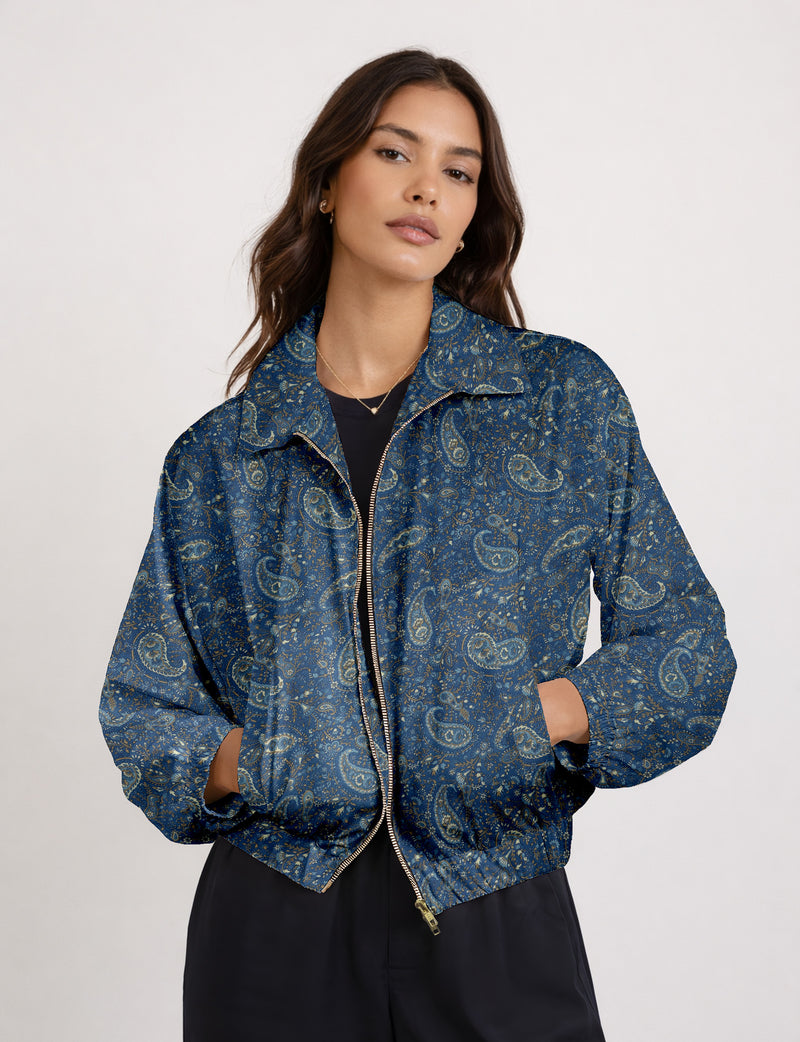 Brown floral bomber jacket with front zipper, elastic cuffs and hem, hanging on white hanger, red floral inner lining visible