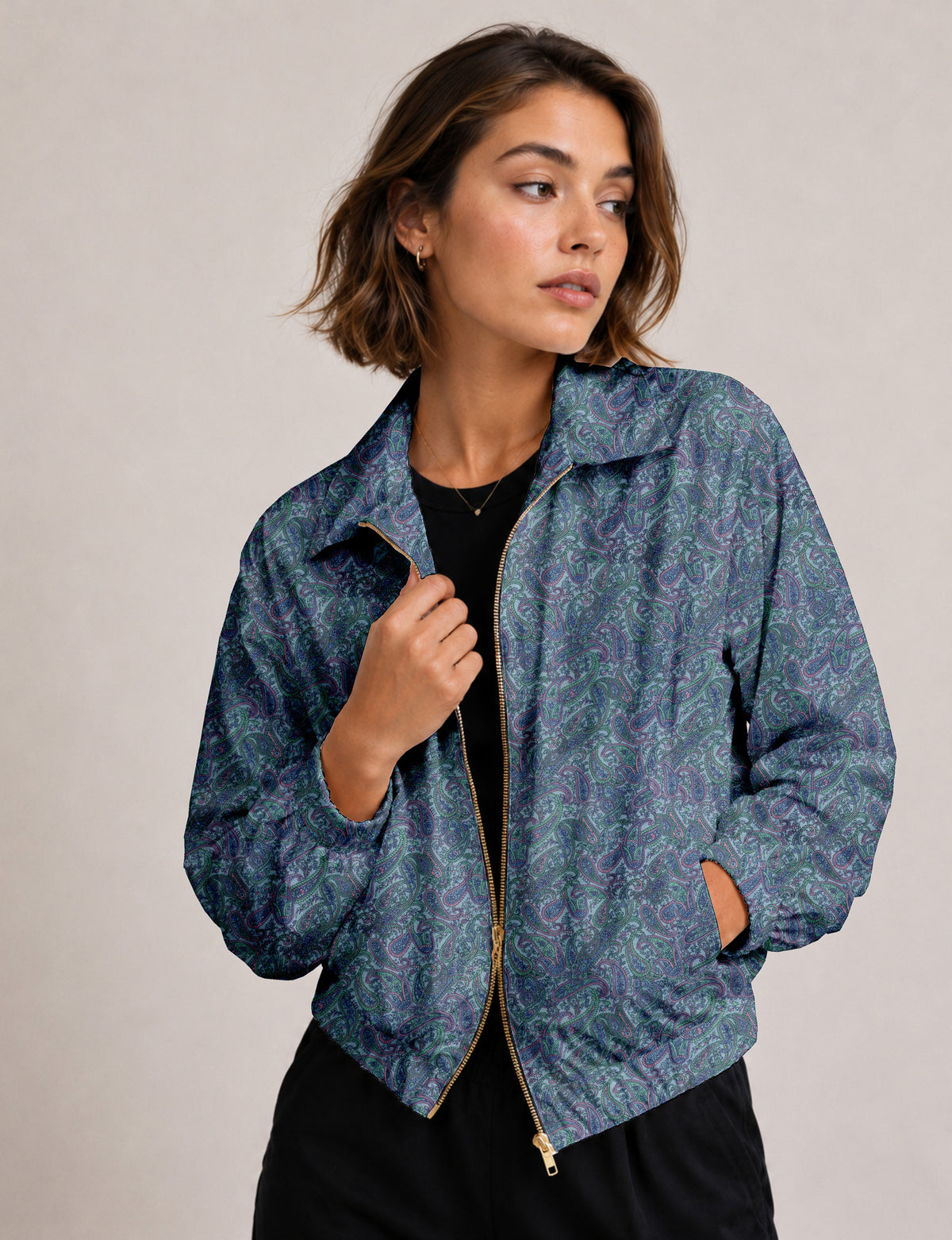 Woman wearing a yellow floral bomber jacket with front zipper, elastic cuffs, and side pockets, shown from front view
