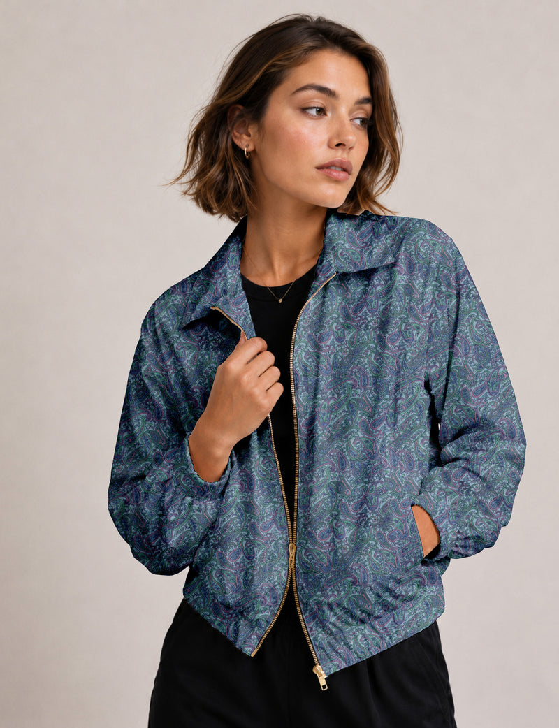 Woman wearing a yellow floral bomber jacket with front zipper, elastic cuffs, and side pockets, shown from front view