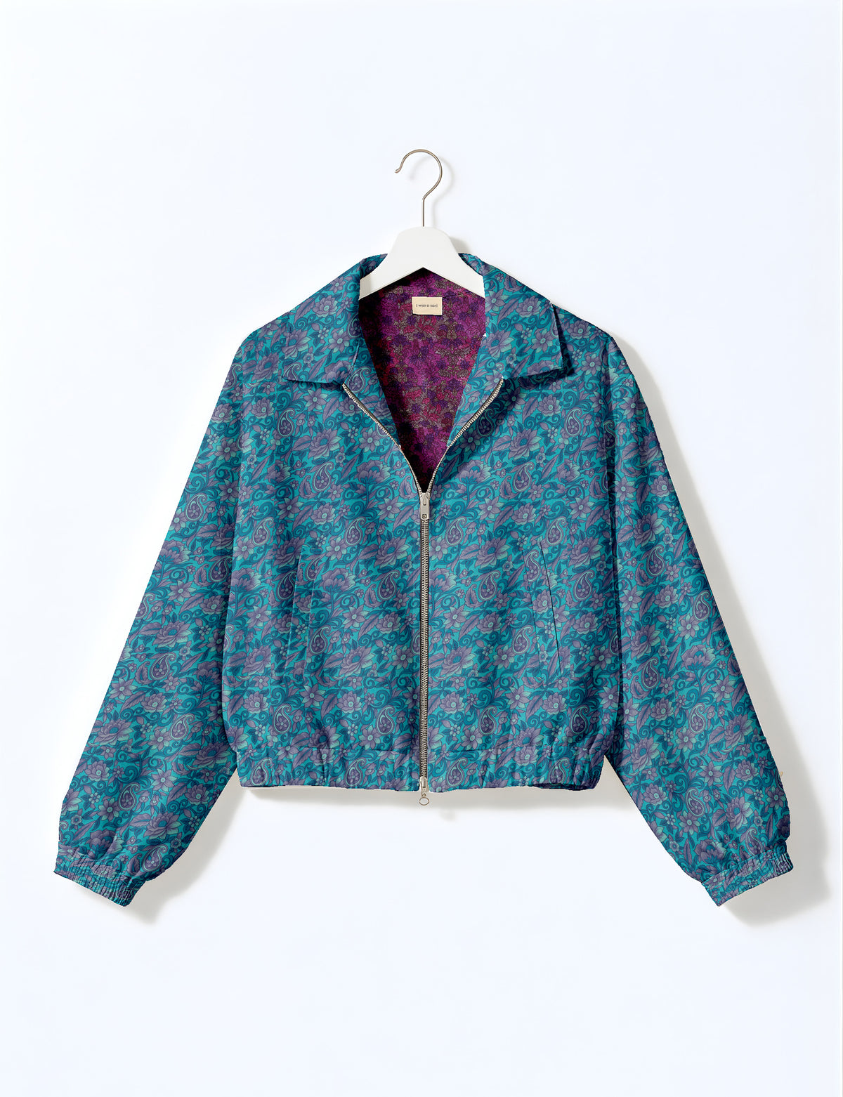Woman wearing a yellow floral bomber jacket with front zipper, elastic cuffs, and side pockets, shown from front view