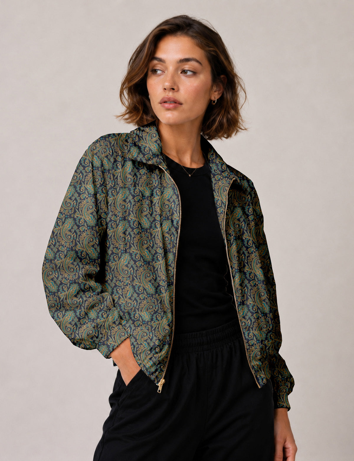 Woman wearing a yellow floral bomber jacket with front zipper, elastic cuffs, and side pockets, shown from front view