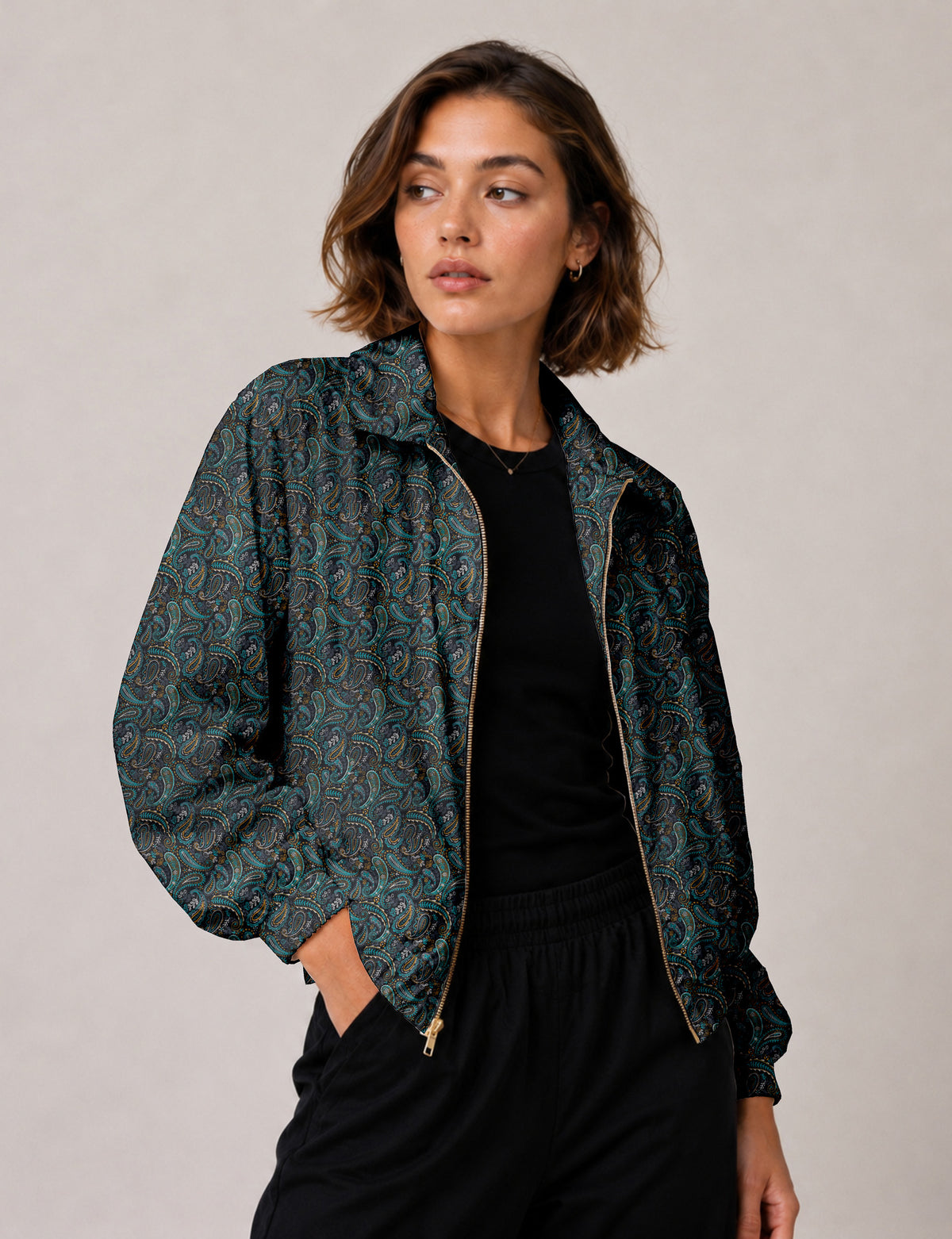 Brown floral bomber jacket with front zipper, elastic cuffs and hem, hanging on white hanger, red floral inner lining visible