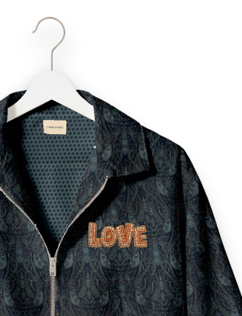 Love Bomber Jacket made from recycled fabric, featuring hand-stitched Aari embroidery. A unique piece of zero-waste clothing, part of the circular fashion movement. Designed with upcycled materials for a stylish yet environmentally friendly clothing choice.