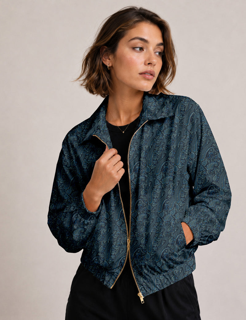 Woman wearing a yellow floral bomber jacket with front zipper, elastic cuffs, and side pockets, shown from front view