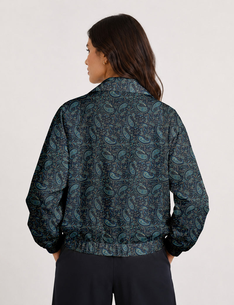 Brown floral bomber jacket with front zipper, elastic cuffs and hem, hanging on white hanger, red floral inner lining visible