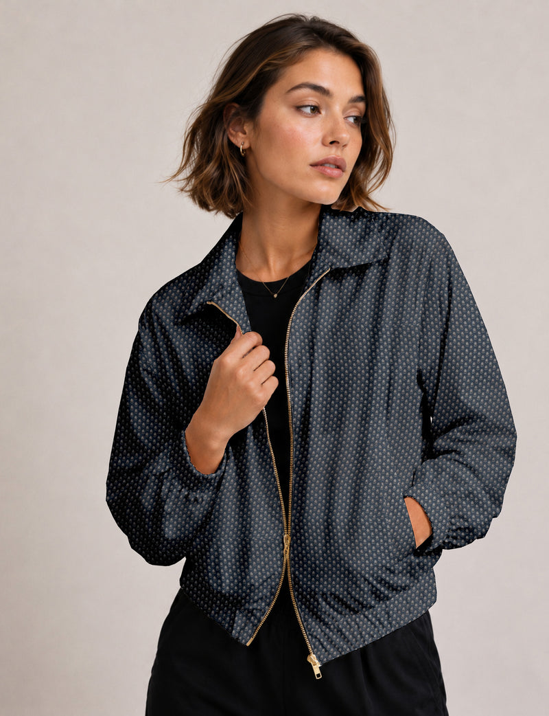 Woman wearing a yellow floral bomber jacket with front zipper, elastic cuffs, and side pockets, shown from front view