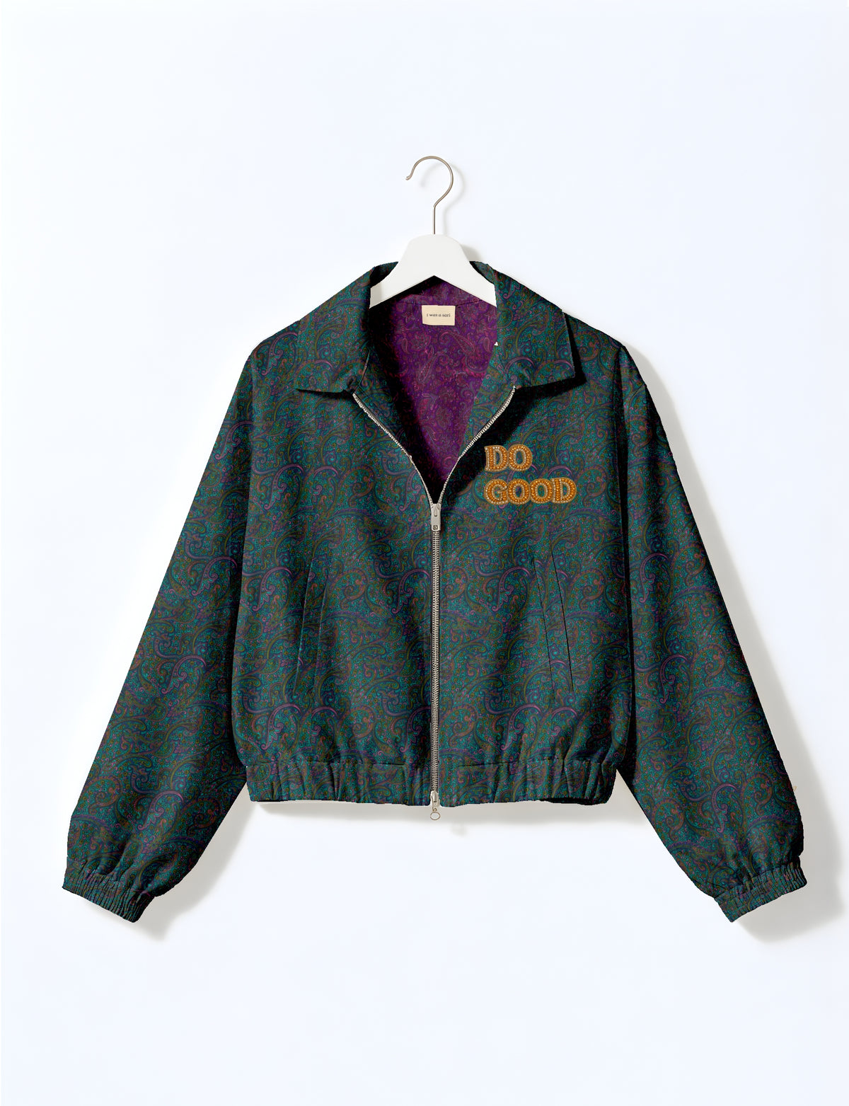Gold cropped DO GOOD bomber jacket featuring hand-embroidered lettering on the left chest, contrasting inner lining and two functional pockets.