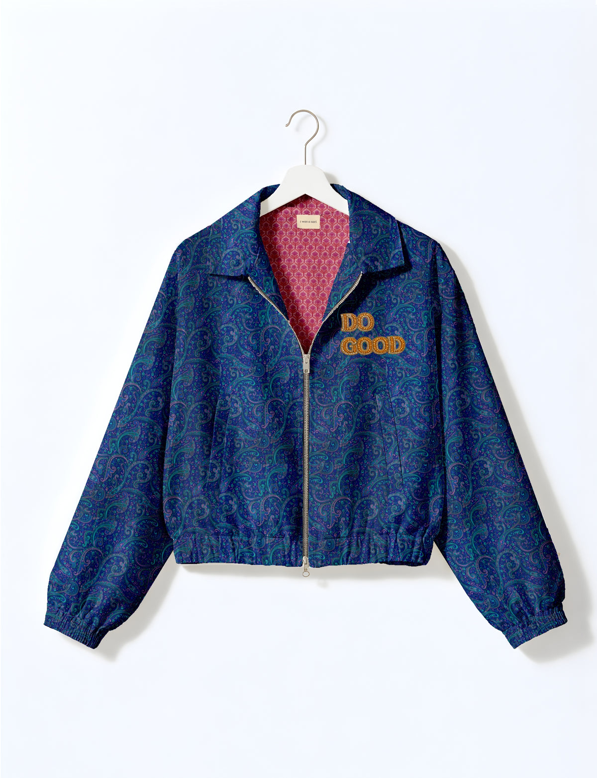 Gold cropped DO GOOD bomber jacket featuring hand-embroidered lettering on the left chest, contrasting inner lining and two functional pockets.