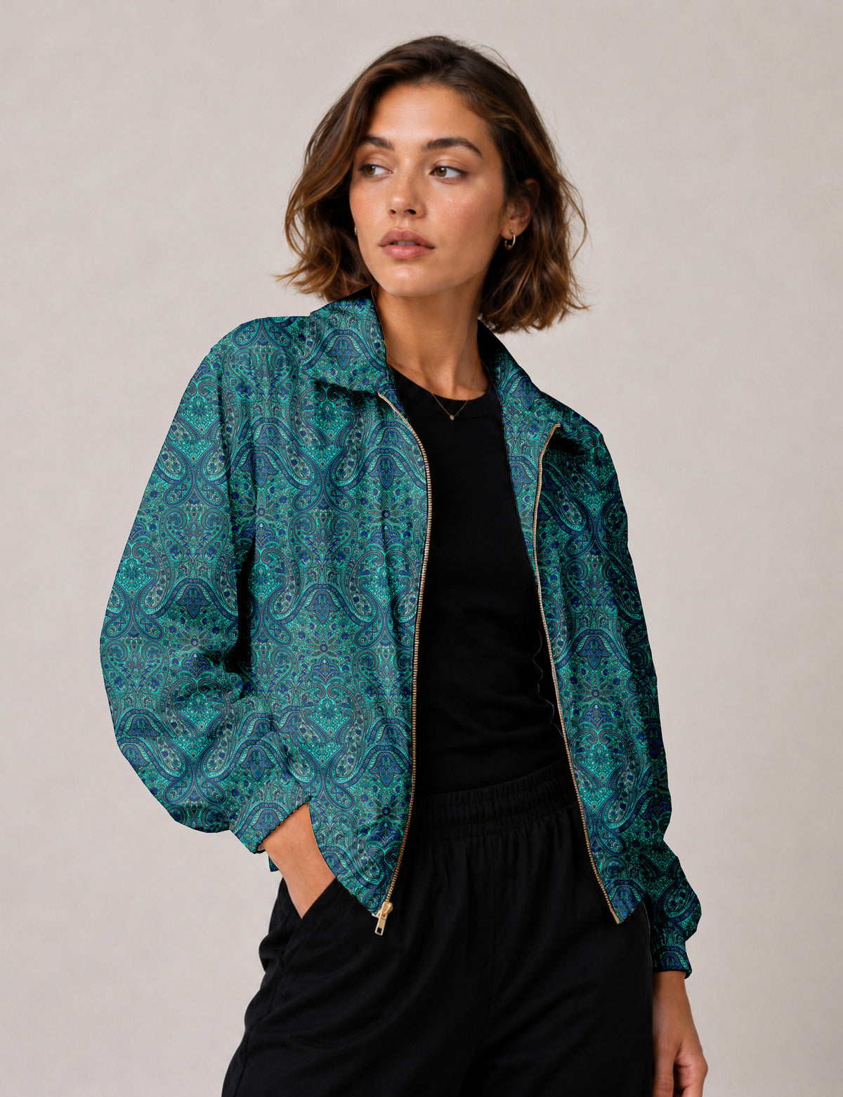 Woman wearing a yellow floral bomber jacket with front zipper, elastic cuffs, and side pockets, shown from front view