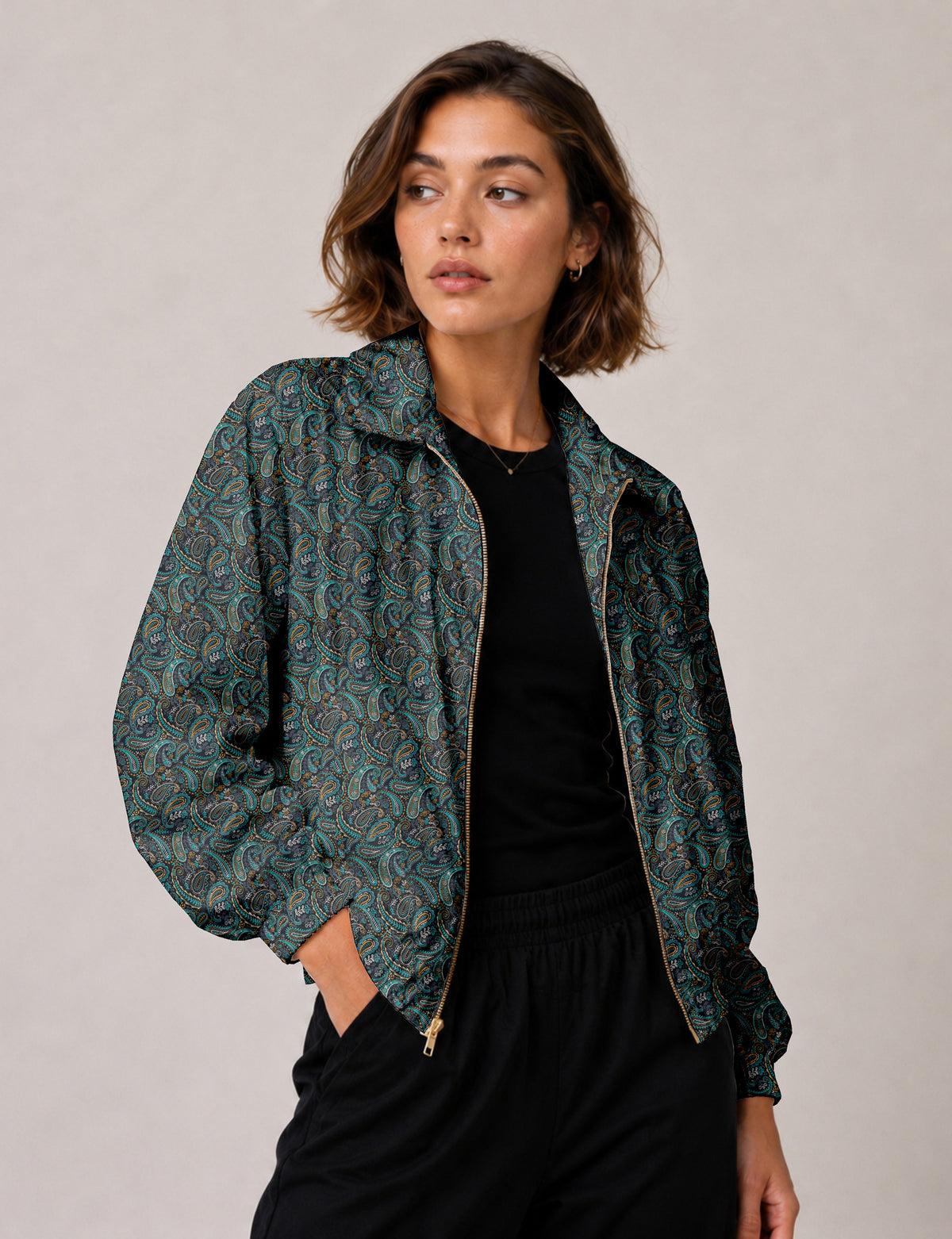 Brown floral bomber jacket with front zipper, elastic cuffs and hem, hanging on white hanger, red floral inner lining visible