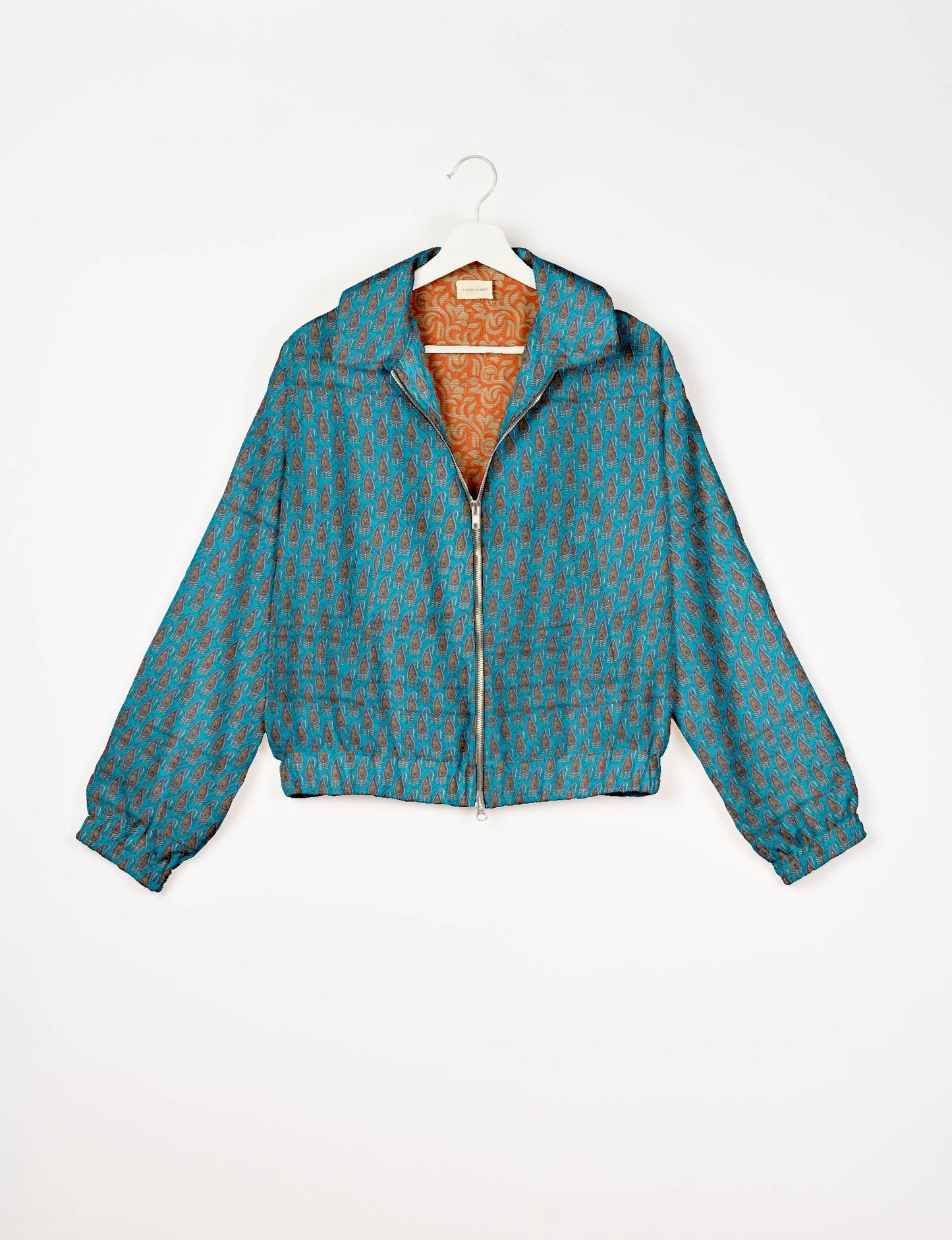 Upcycled Bomber Jacket made from recycled sari materials, featuring a cute cropped shape, elasticated hem and cuffs, and contrast sari print lining. Sustainable apparel promoting eco-friendly fashion and ethical clothing.