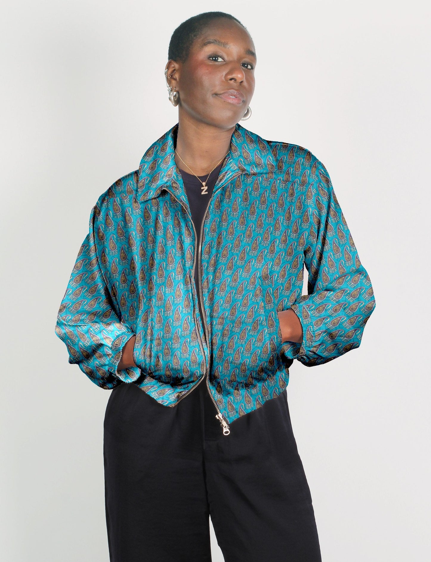Upcycled Bomber Jacket made from recycled sari materials, featuring a cute cropped shape, elasticated hem and cuffs, and contrast sari print lining. Sustainable apparel promoting eco-friendly fashion and ethical clothing.