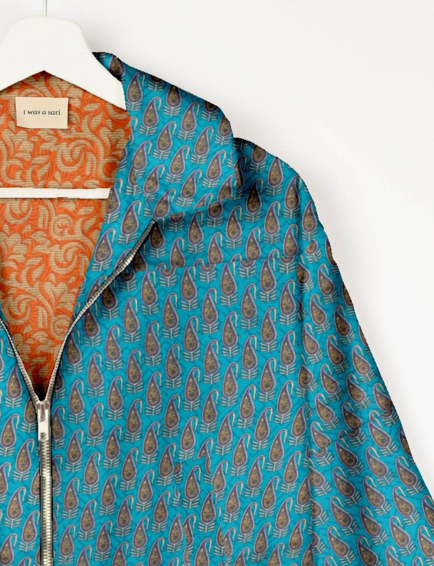 Upcycled Bomber Jacket made from recycled sari materials, featuring a cute cropped shape, elasticated hem and cuffs, and contrast sari print lining. Sustainable apparel promoting eco-friendly fashion and ethical clothing.