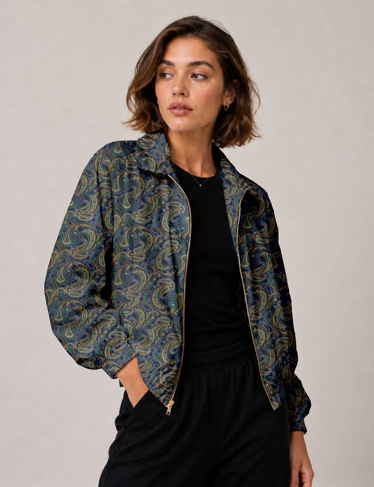 Brown floral bomber jacket with front zipper, elastic cuffs and hem, hanging on white hanger, red floral inner lining visible