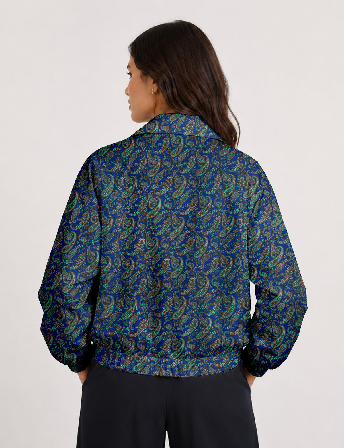 Woman wearing a yellow floral bomber jacket with front zipper, elastic cuffs, and side pockets, shown from front view