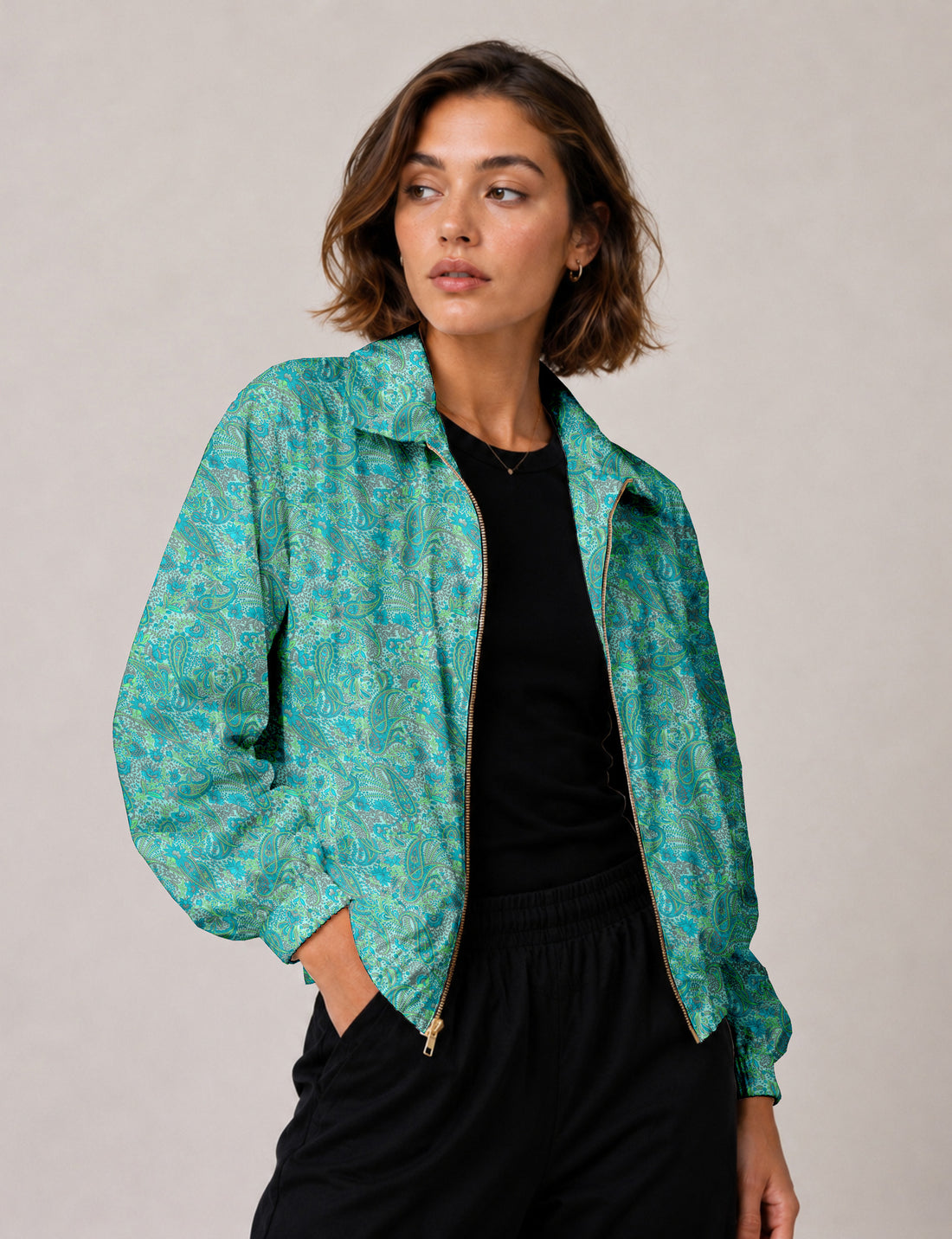 Woman wearing an I was a Sari bomber jacket made from a blue paisley sari