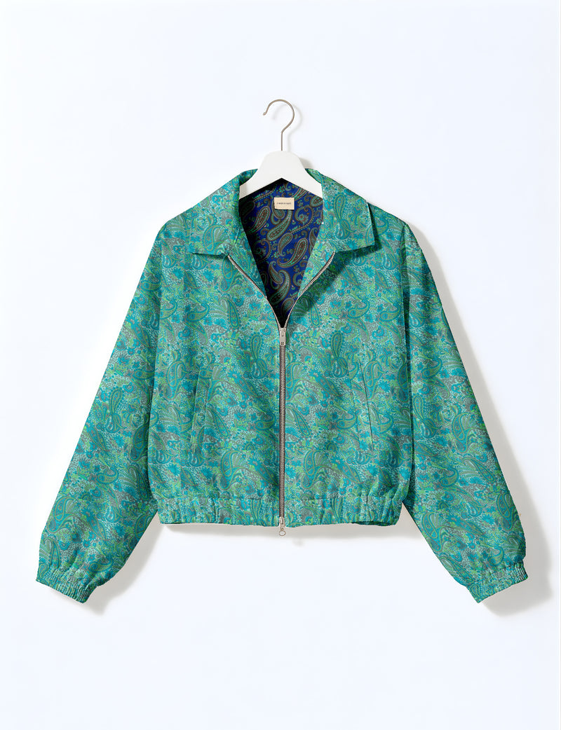 Woman wearing a yellow floral bomber jacket with front zipper, elastic cuffs, and side pockets, shown from front view