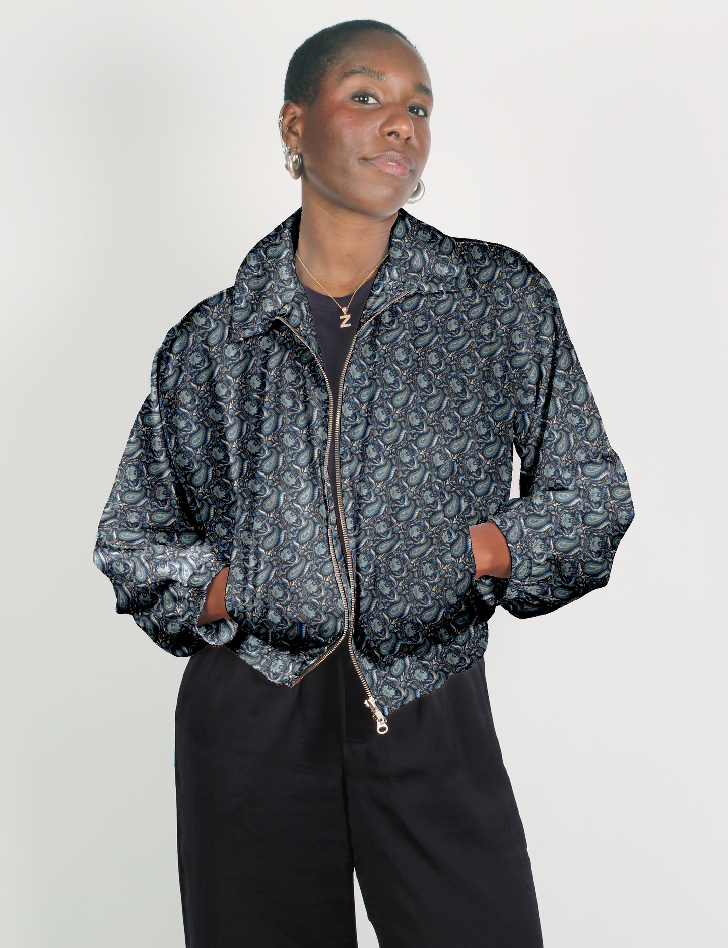 Upcycled Bomber Jacket made from recycled sari materials, featuring a cute cropped shape, elasticated hem and cuffs, and contrast sari print lining. Sustainable apparel promoting eco-friendly fashion and ethical clothing.