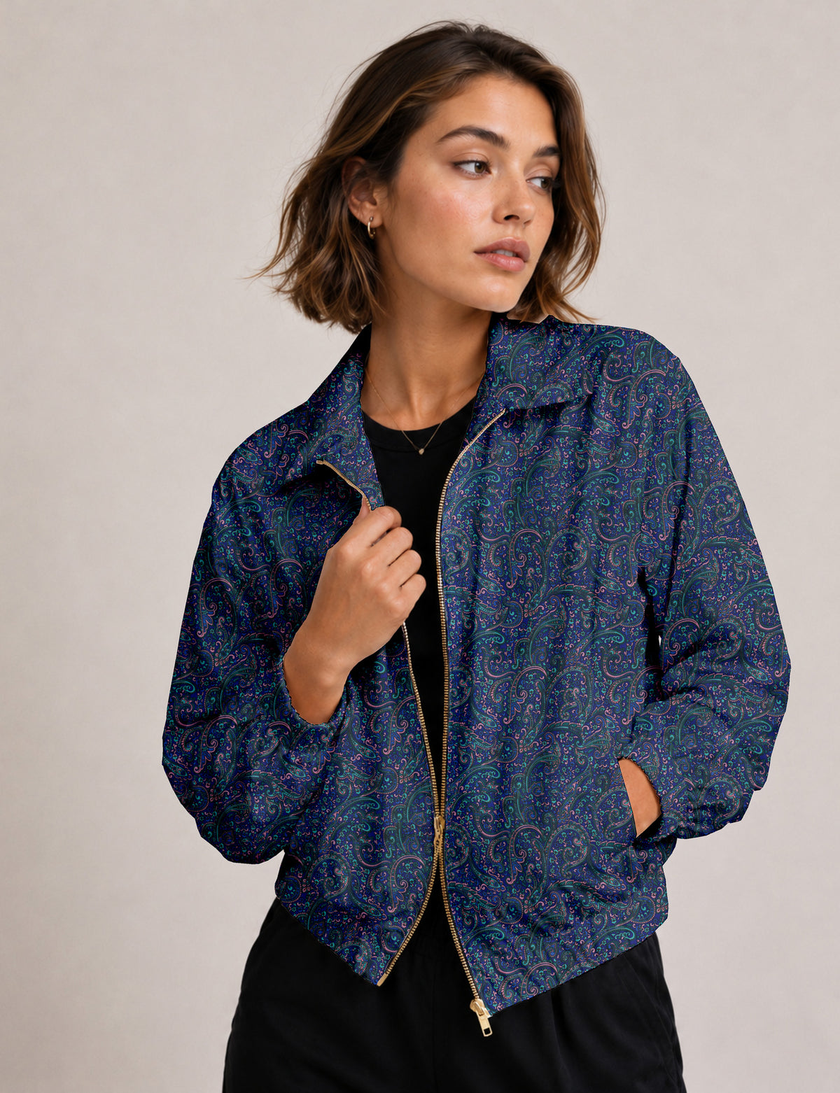 Brown floral bomber jacket with front zipper, elastic cuffs and hem, hanging on white hanger, red floral inner lining visible