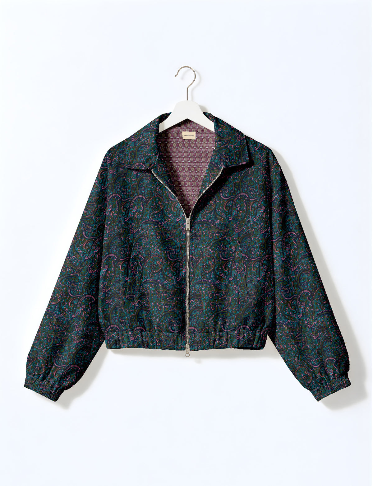 Brown floral bomber jacket with front zipper, elastic cuffs and hem, hanging on white hanger, red floral inner lining visible