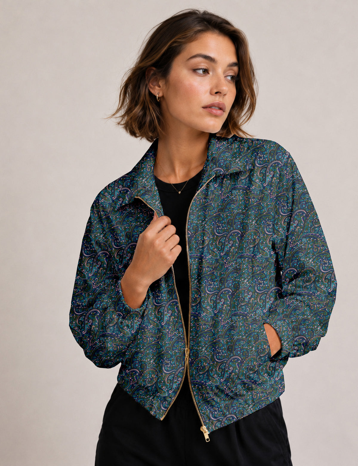 Brown floral bomber jacket with front zipper, elastic cuffs and hem, hanging on white hanger, red floral inner lining visible