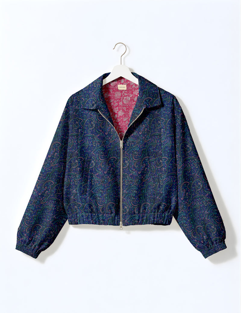 Brown floral bomber jacket with front zipper, elastic cuffs and hem, hanging on white hanger, red floral inner lining visible