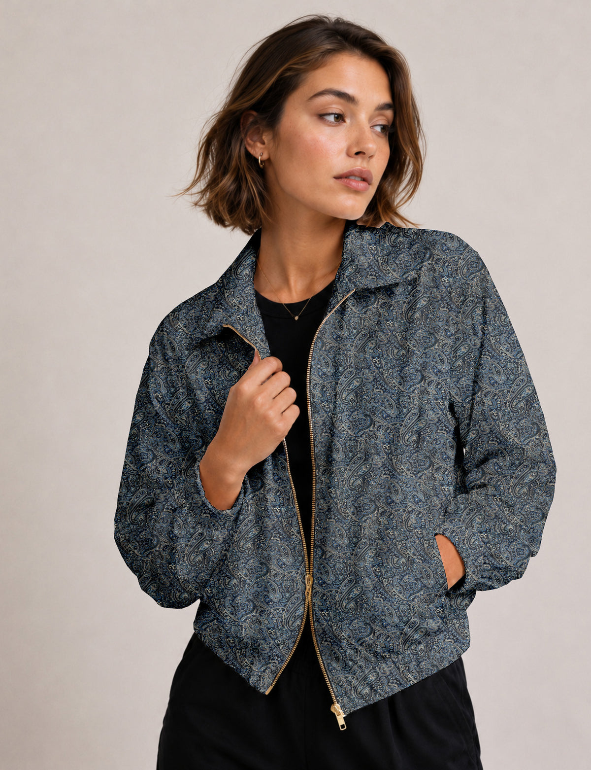 Woman wearing a yellow floral bomber jacket with front zipper, elastic cuffs, and side pockets, shown from front view