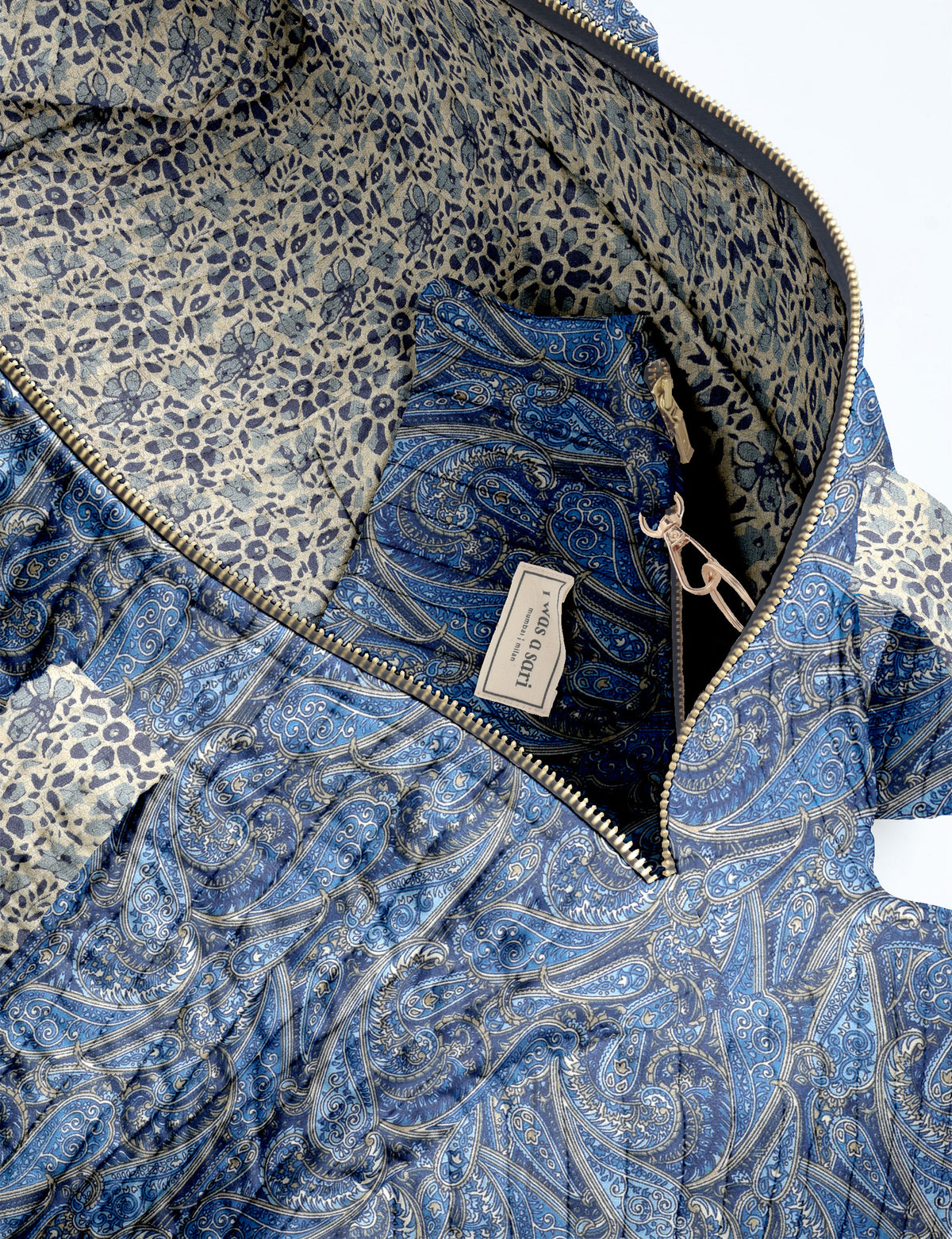 Brown paisley quilted bowling bag with dual handles, front zipper pocket, and "I was a sari" label on front side