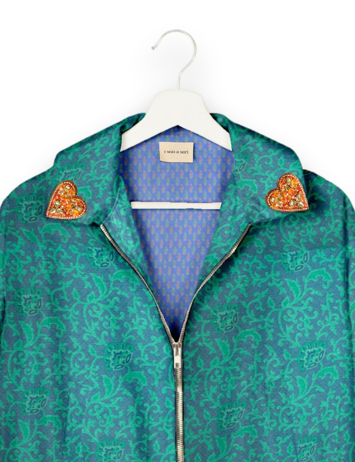 Make a bold statement with our Heart Drop Earrings, a symbol of conscious luxury and ethical fashion. Handcrafted using the intricate Aari embroidery technique, these earrings are made from upcycled sari fabric, embracing slow fashion and zero waste clothing. Elevate your look with sustainable apparel that supports fair trade fashion while reducing textile waste. Choose eco-friendly fashion that speaks of love, artistry, and responsibility.