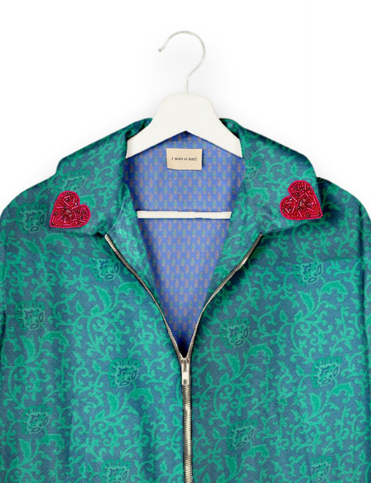 Make a bold statement with our Heart Drop Earrings, a symbol of conscious luxury and ethical fashion. Handcrafted using the intricate Aari embroidery technique, these earrings are made from upcycled sari fabric, embracing slow fashion and zero waste clothing. Elevate your look with sustainable apparel that supports fair trade fashion while reducing textile waste. Choose eco-friendly fashion that speaks of love, artistry, and responsibility.