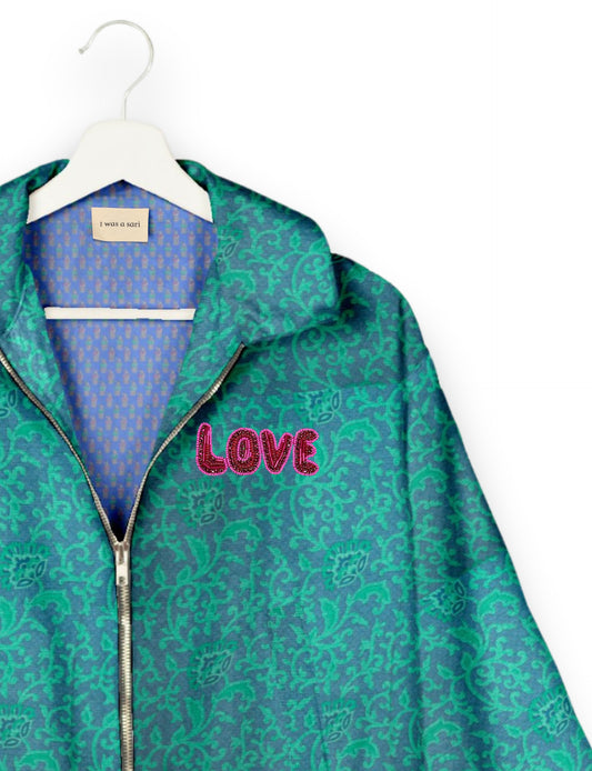 Love Bomber Jacket made from recycled fabric, featuring hand-stitched Aari embroidery. A unique piece of zero-waste clothing, part of the circular fashion movement. Designed with upcycled materials for a stylish yet environmentally friendly clothing choice.