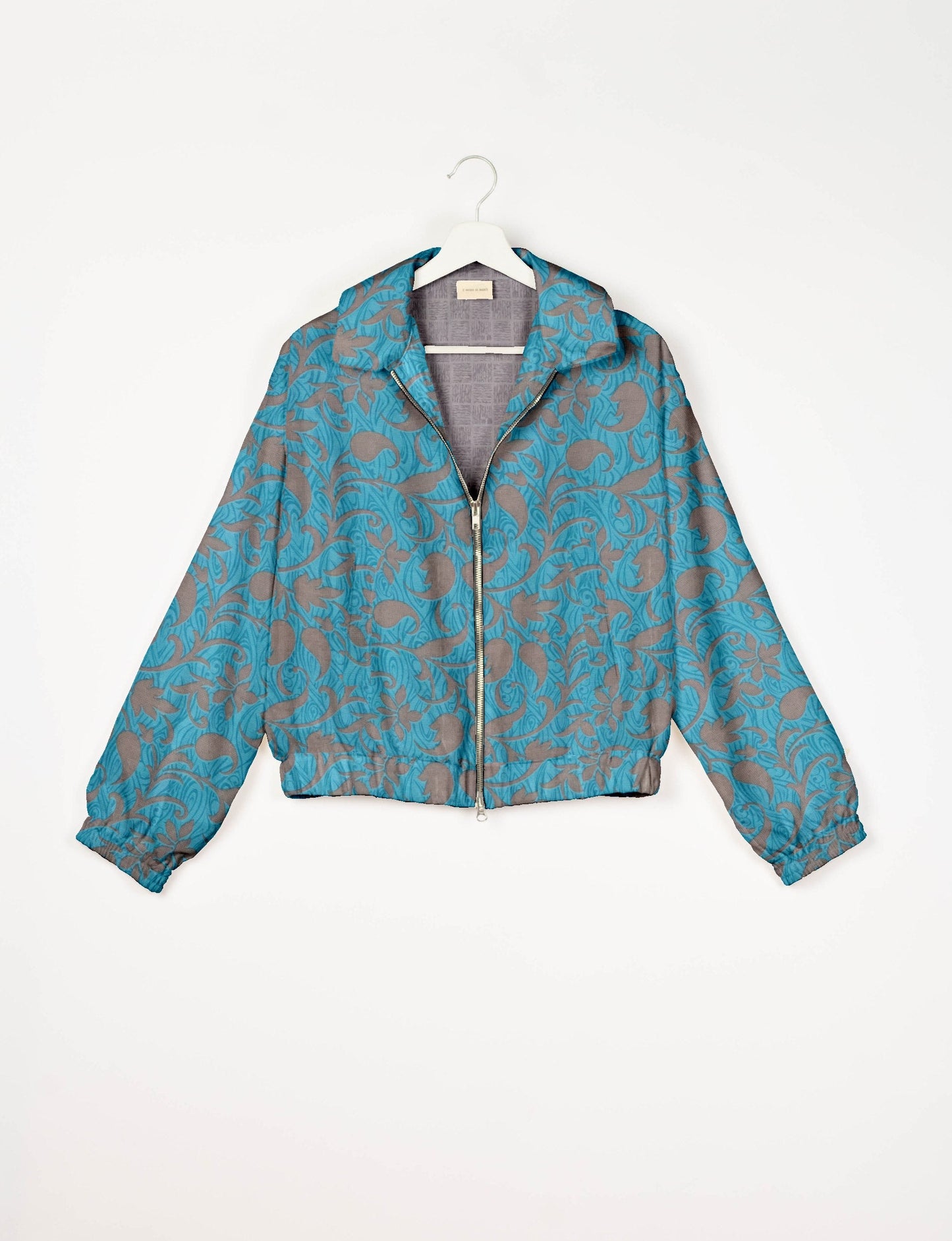 Stylish BOMBER JACKET, an upcycled clothing masterpiece with a cute cropped shape, elasticated details, and detachable metallic zipper. Contrast sari print lining adds a unique touch. Explore sustainable and eco-friendly fashion.