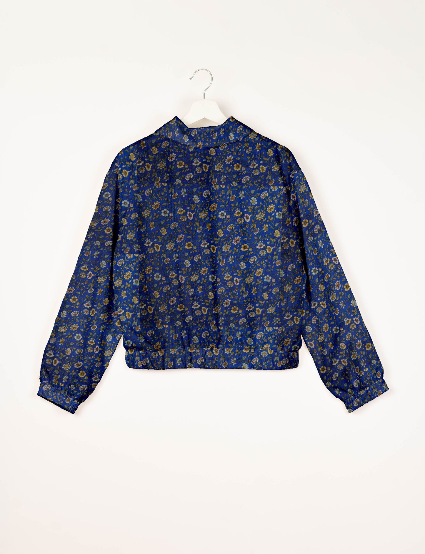 Upcycled Bomber Jacket made from recycled sari materials, featuring a cute cropped shape, elasticated hem and cuffs, and contrast sari print lining. Sustainable apparel promoting eco-friendly fashion and ethical clothing.