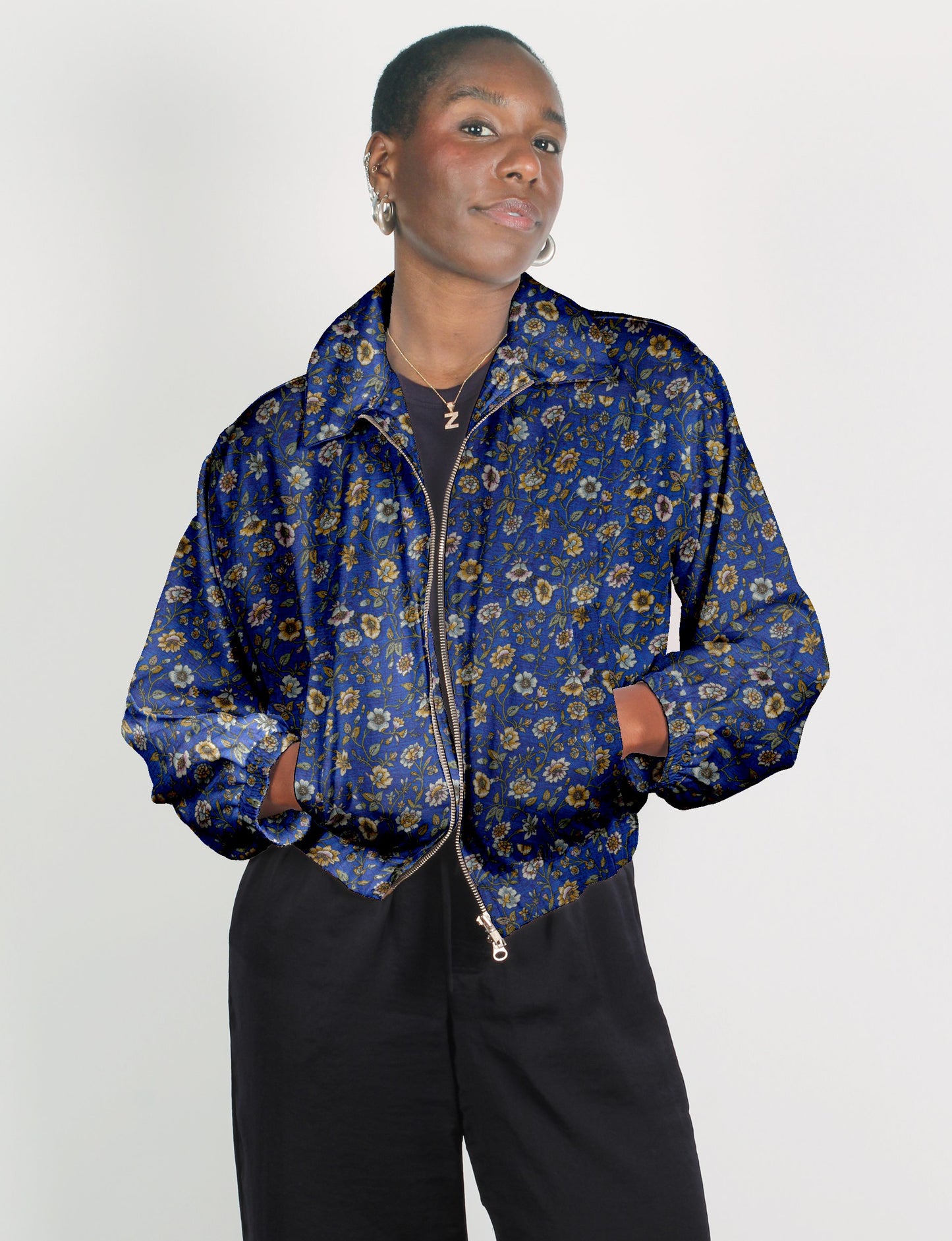 Upcycled Bomber Jacket made from recycled sari materials, featuring a cute cropped shape, elasticated hem and cuffs, and contrast sari print lining. Sustainable apparel promoting eco-friendly fashion and ethical clothing.