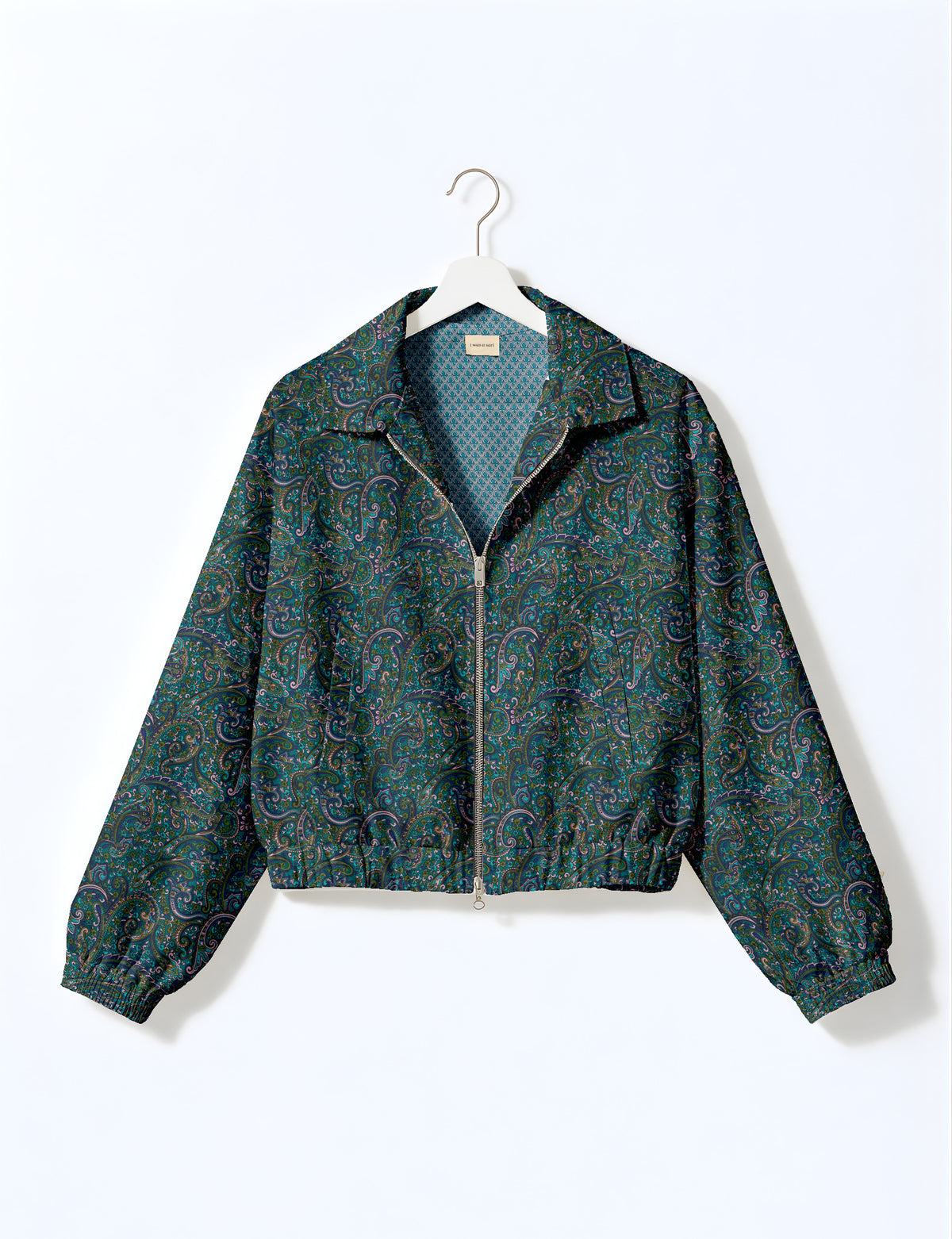 Brown floral bomber jacket with front zipper, elastic cuffs and hem, hanging on white hanger, red floral inner lining visible