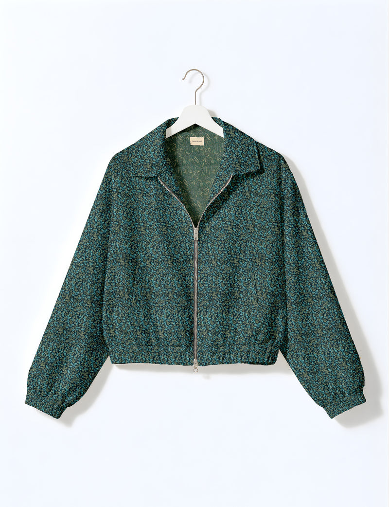 Brown floral bomber jacket with front zipper, elastic cuffs and hem, hanging on white hanger, red floral inner lining visible