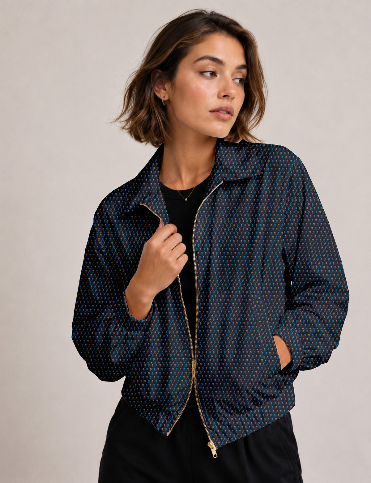 Woman wearing a yellow floral bomber jacket with front zipper, elastic cuffs, and side pockets, shown from front view