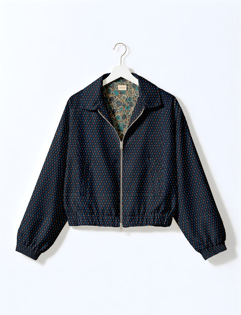 Brown floral bomber jacket with front zipper, elastic cuffs and hem, hanging on white hanger, red floral inner lining visible