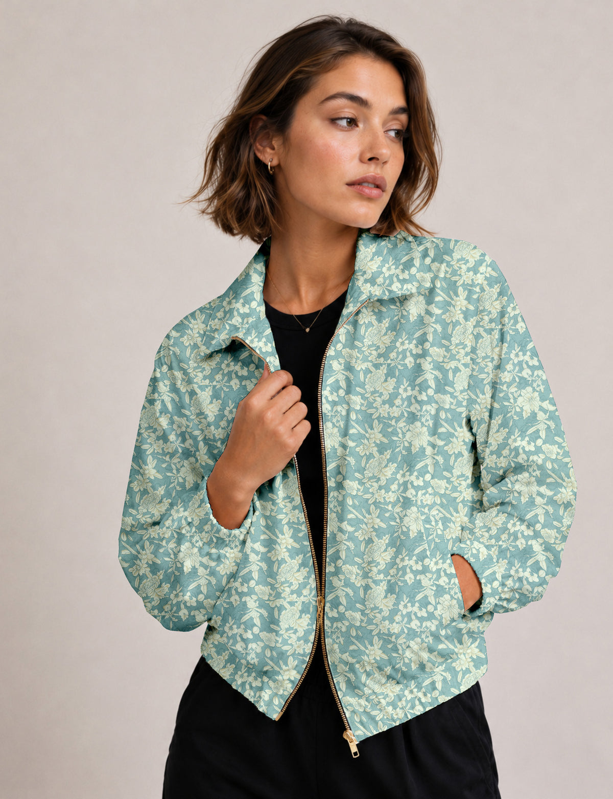 Brown floral bomber jacket with front zipper, elastic cuffs and hem, hanging on white hanger, red floral inner lining visible