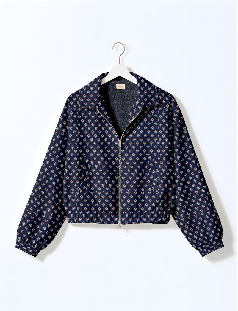 Brown floral bomber jacket with front zipper, elastic cuffs and hem, hanging on white hanger, red floral inner lining visible